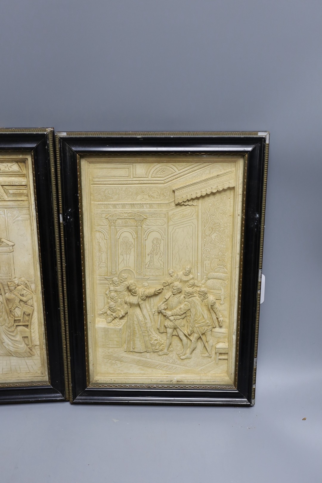 A pair of plaster relief panels of the court of Elizabeth I in glazed wooden frames - 30 x 19cm